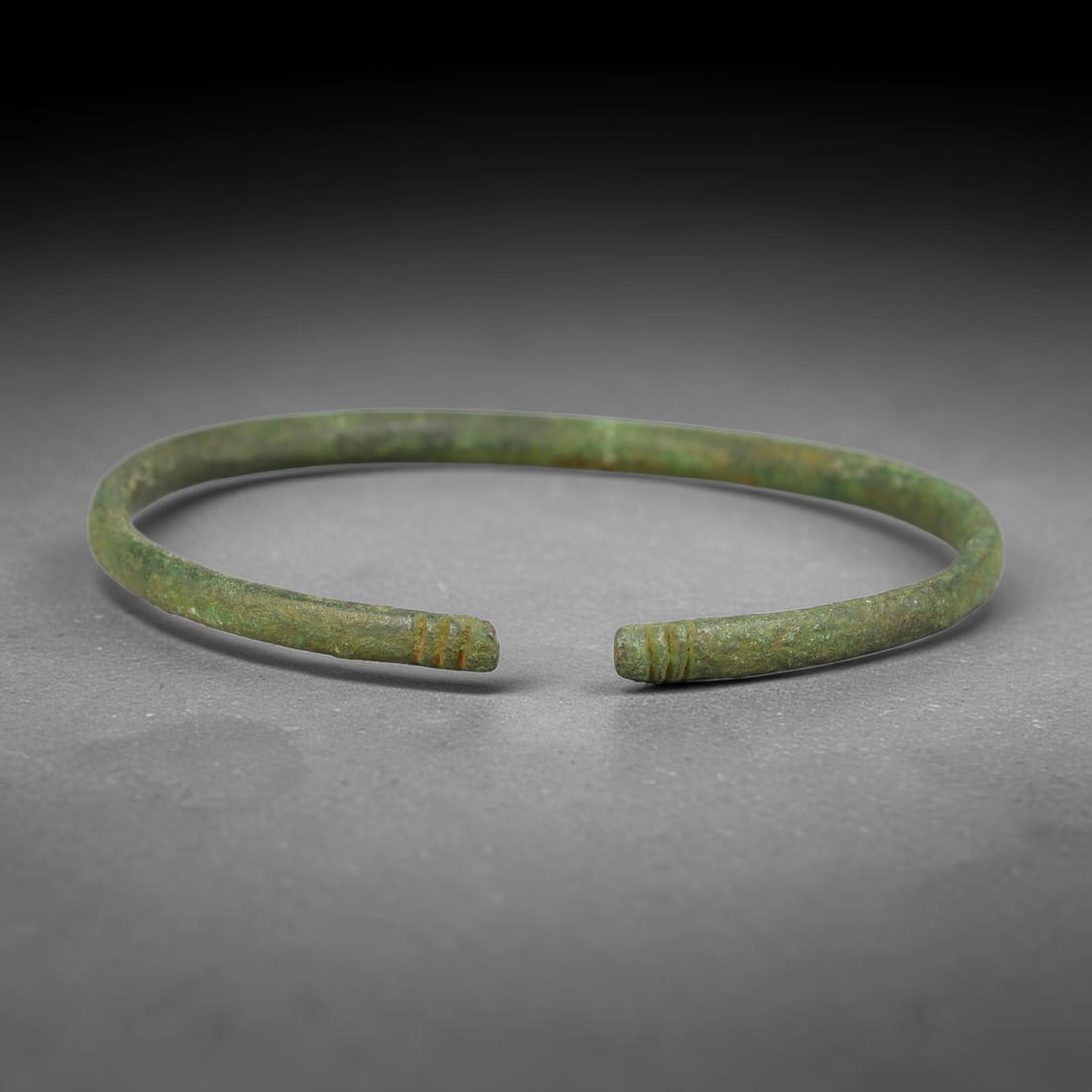Ancient Roman Republic & Imperial Roman Bronze Open Armilla Bracelet (509 BCE-476 CE), 13AC: This antique solid bronze open cuff armilla bracelet originates from Roman Republic & Imperial Roman Culture, widely produced utilitarian and symbolic adornment worn by civilian women and awarded as m