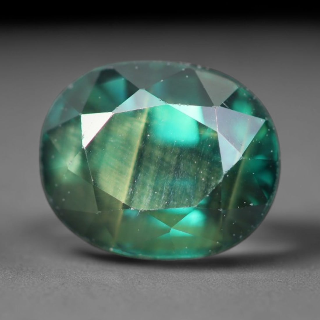 1.70ct Natural Australian Teal Faceted Sapphire Loose Gemstone, 9BA: This skillfully faceted sapphire features rich saturated body tone with fine microscopic mineral inclusions scattered evenly across its polished reflective planes within its 7x5.7x4.5mm calibrated dim