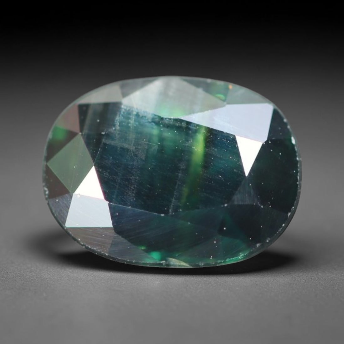 2.19ct Natural Australian Teal Faceted Sapphire Loose Gemstone, 5BA: This skillfully faceted sapphire features rich saturated body tone with fine microscopic mineral inclusions scattered evenly across its polished reflective planes within its 8.8x6.6x3.7mm calibrated d