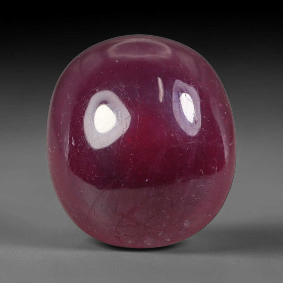 10.66ct Natural Mozambican Deep Crimson Red Ruby Cabochon Loose Gemstone, 19AS: This smoothly polished cabochon ruby holds a rich deep crimson red body hue, covered with fine natural surface fracturing and tiny scattered mineral specks across its domed polished surface within its