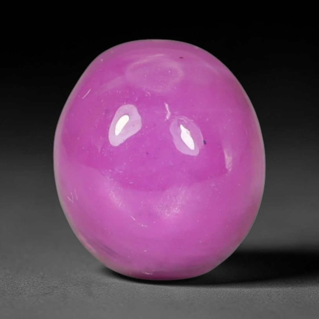 5.00ct Natural Mozambican Soft Bubblegum Pink Ruby Cabochon Loose Gemstone, 99AR: This smoothly polished domed ruby cabochon displays a gentle soft bubblegum pink body tone with faint natural linear mineral veining and tiny scattered rust-hued mineral flecks embedded within its tra