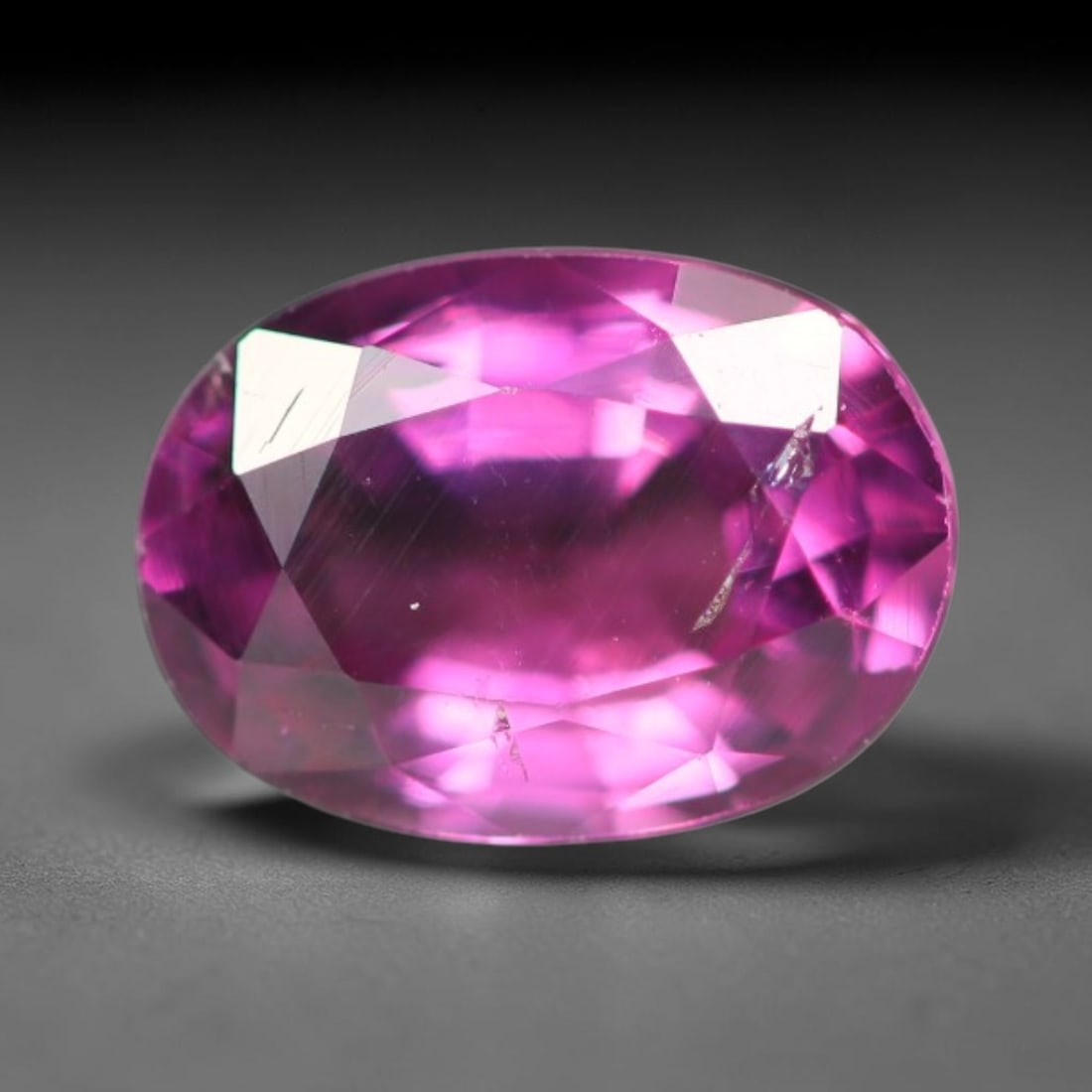 1.15ct Natural Tanzanian Rhodolite Grape Garnet Faceted Loose Gemstone, 79BA: This expertly faceted grape garnet, a scarce saturated purple-magenta rhodolite variant, features transparent crystal structure dotted with faint microscopic mineral specks within its precisely cut re