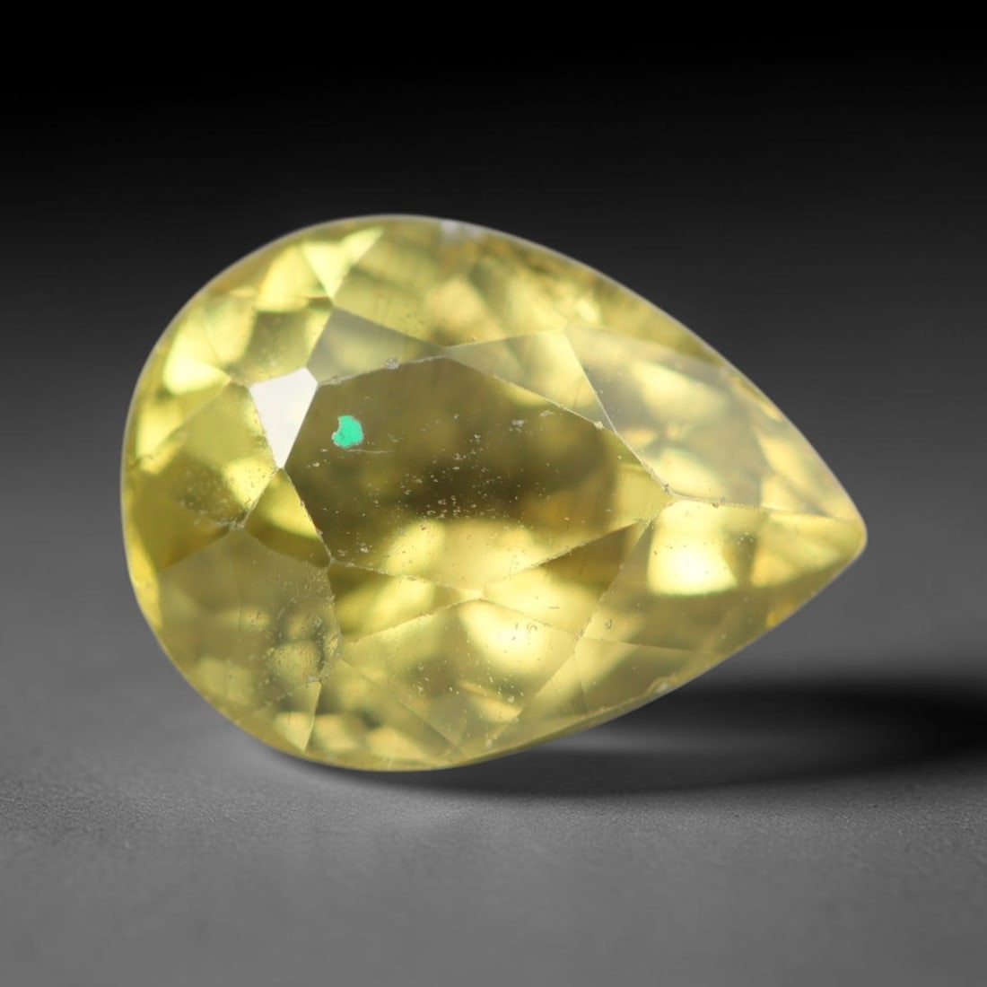 2.28ct Natural Mexican Lemon Yellow Faceted Apatite Loose Gemstone, 33BC: This expertly faceted yellow apatite holds translucent pale lemon yellow crystal structure with faint tiny internal mineral specks and subtle fine linear markings visible beneath its precisely polishe
