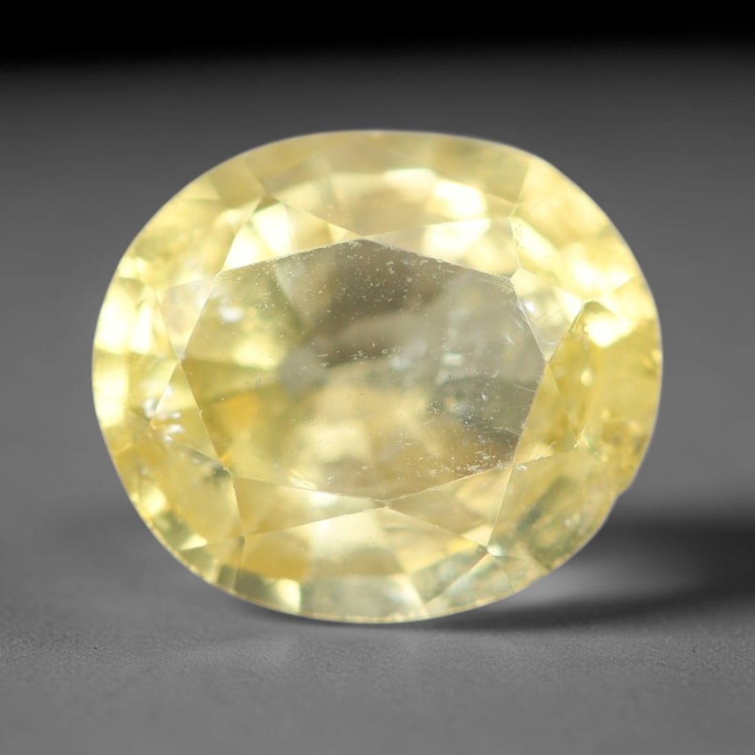 1.70ct Natural Mexican Lemon Yellow Faceted Apatite Loose Gemstone, 52BD: This expertly faceted yellow apatite holds translucent pale lemon yellow crystal structure with faint tiny internal mineral specks and subtle fine linear markings visible beneath its precisely polishe