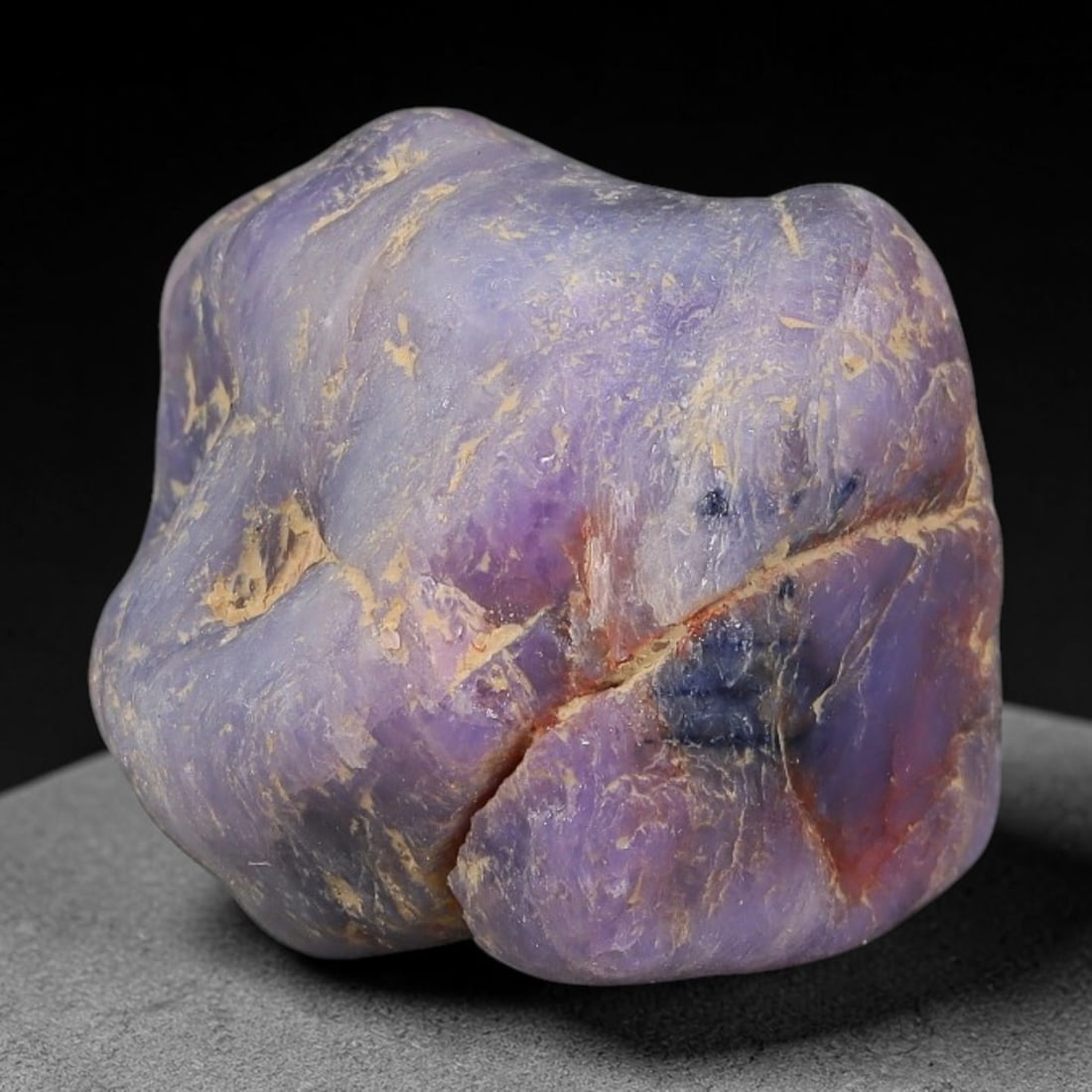 50.80ct Natural Unheated Sri Lankan Purplish Blue Sapphire Rough, 37FC: This natural corundum rough is an unheated purplish blue sapphire sourced from Sri Lankan alluvial gem deposits, featuring an irregular natural native form with residual pale yellow-brown mineral matr