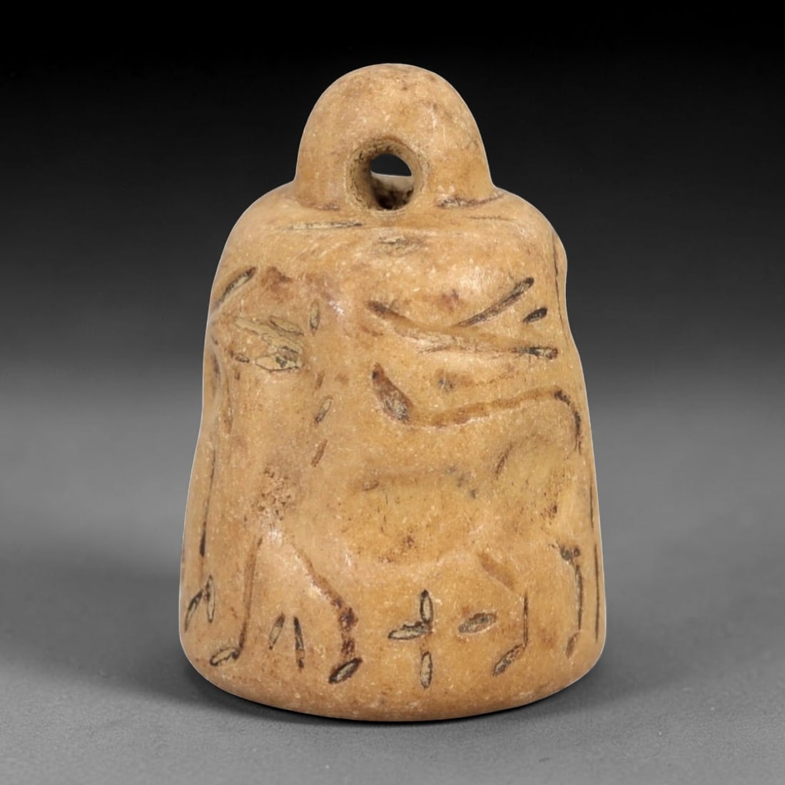 Ancient Bell-Shaped Stone Stamp Seal - Near Eastern Zoomorphic Impression, 33AM: This bell-shaped stamp seal is carved from a pale, granular stone with a warm earthy patina, exhibiting subtle surface striations and natural mineral inclusions. The form features a rounded, pierced s