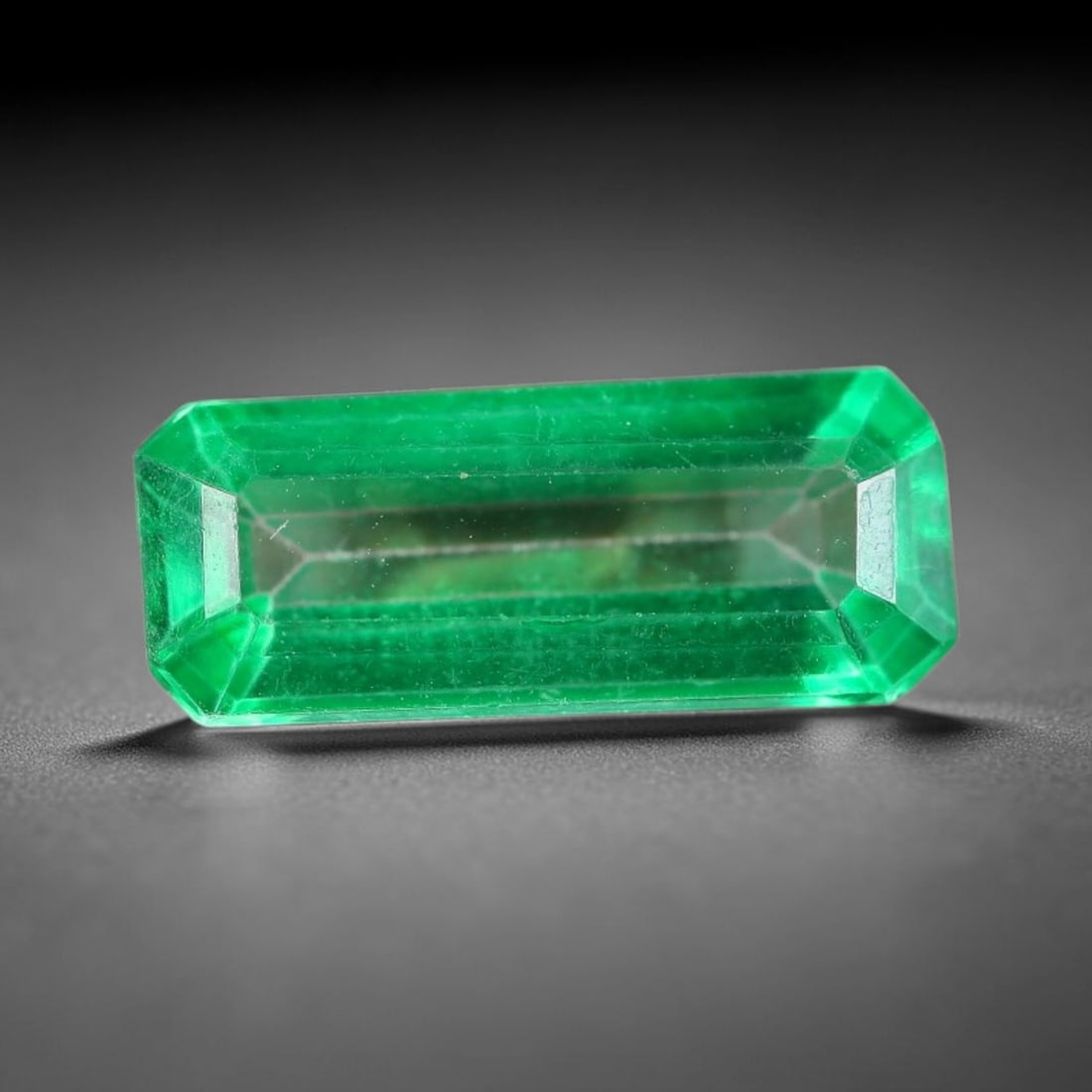 3.48 Carats Natural Brazil Vivid Green Topaz Loose Gemstone, 19FE: This natural Brazil topaz with recorded dimensions of 14.3x6x4mm, featuring a bright saturated green tone achieved via color coating treatment across the gem surface, with faint subtle natural interna