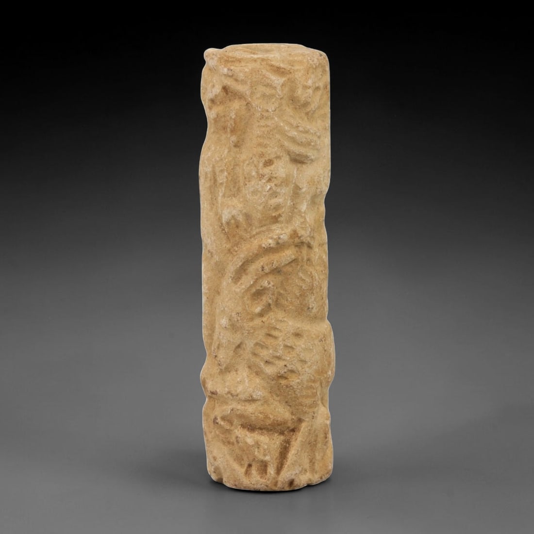 Ancient Limestone Cylinder Bead - Carved Relief Figurine, 8AH: Carved from limestone, this ancient cylinder bead features a slender, tubular form with raised relief detailing depicting a stylized humanoid figure, typical of ornamental use in early cultural contex