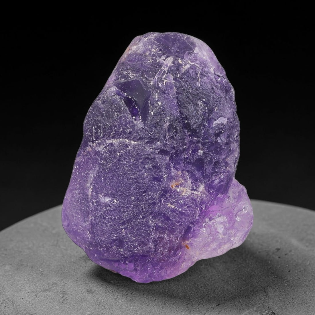 136ct Natural Chinese Deep Violet Purple Fluorite Rough, 1AT: This rugged fluorite rough boasts rich layered violet purple saturation blended with warm rust-colored mineral inclusions that streak its uneven raw surface, soft translucency lets light drift through