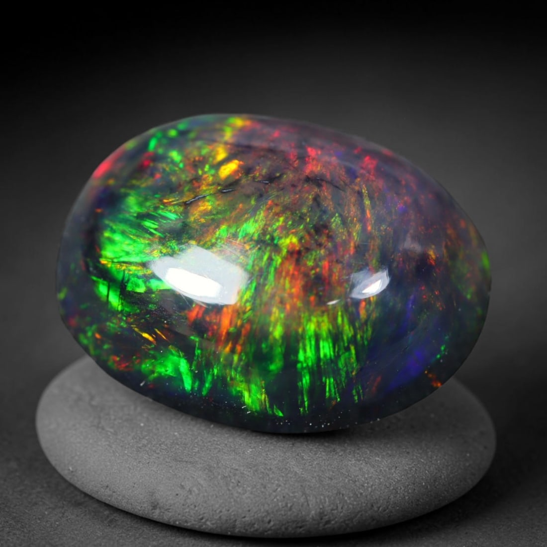 1.53ct Natural Ethiopian Welo Black Smoked Opal Cabochon Loose Gemstone, 8FL: This fully polished Ethiopian Welo opal features a dark smoked base with vivid, sweeping play-of-color shifting across its glossy dome surface, measured at 10x8x4mm. The black smoke treatment deepens 