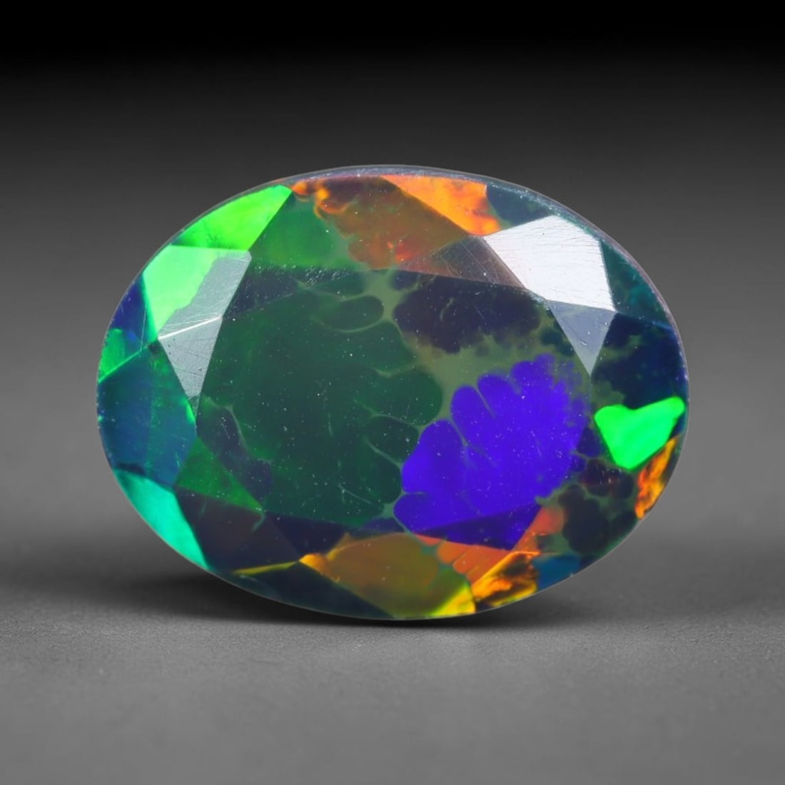 2.16ct Natural Ethiopian Welo Black Smoked Faceted Opal, 11EB: This fully faceted finished opal specimen displays vivid shifting play of color across polished geometric facets within its 10x7.8x6.1mm calibrated dimensions, the dark base body amplifies light movem