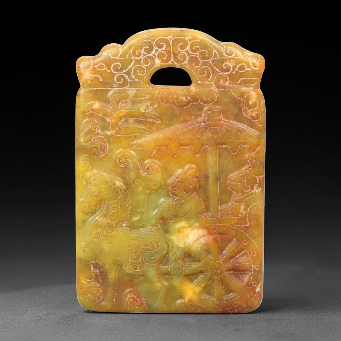 A Chinese Archaistic-Style Jade Figural Plaque, 45FH: Carved from yellow-green jade with mottled tonal variation, areas of russet staining, and natural inclusions, the plaque is rectangular in form with a scalloped upper edge and a pierced aperture for s