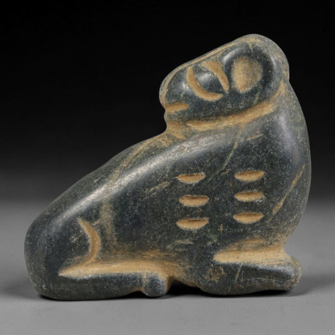 Ancient Mesopotamian Dark Stone Recumbent Feline Zoomorphic Amulet, 71AA: Genuine ancient Mesopotamian spiritual talisman hand-carved from dark polished metamorphic stone, measuring 3.3cm x 2.5cm. The miniature carving depicts a stylized recumbent resting feline with rounde