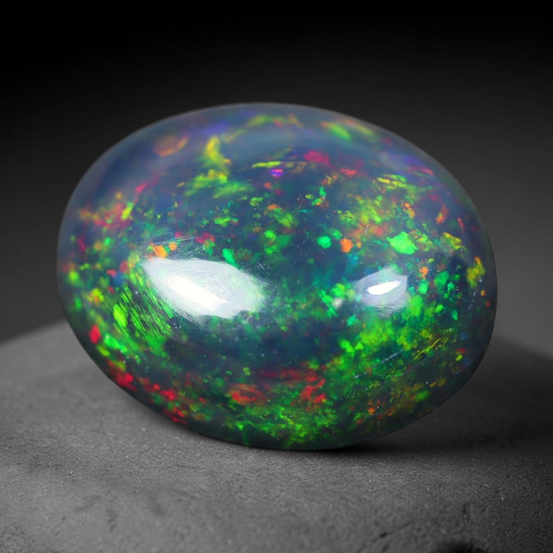 2.28ct Natural Ethiopian Welo Black Smoked Opal Cabochon Loose Gemstone, 36FL: This fully polished Ethiopian Welo opal features a dark smoked base with vivid, sweeping play-of-color shifting across its glossy dome surface, measured at 10.9x8.8x5.3mm. The black smoke treatment de