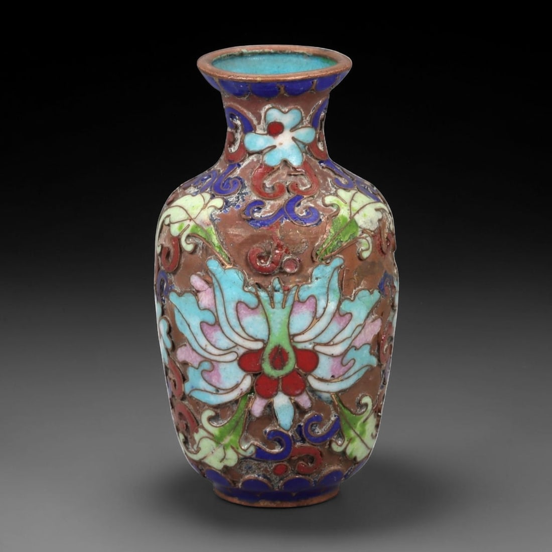 A Chinese Cloisonne Enamel Vase, 20th Century, 2FJ: The vessel is formed from a copper body with applied cloisonne wirework filled with opaque enamel. It is potted with a small ovoid body rising from a narrow foot to a short waisted neck with a flared 
