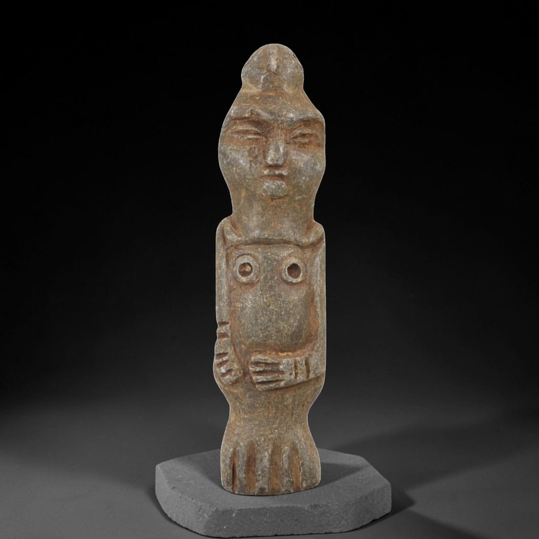 Ancient Stone Idol - Anthropomorphic Votive Figurine, 54AM: This tall, slender stone idol is carved from a coarse-grained, micaceous stone with a heavily weathered, earthy patina ranging from gray to warm brown. The form depicts a stylized standing human figur