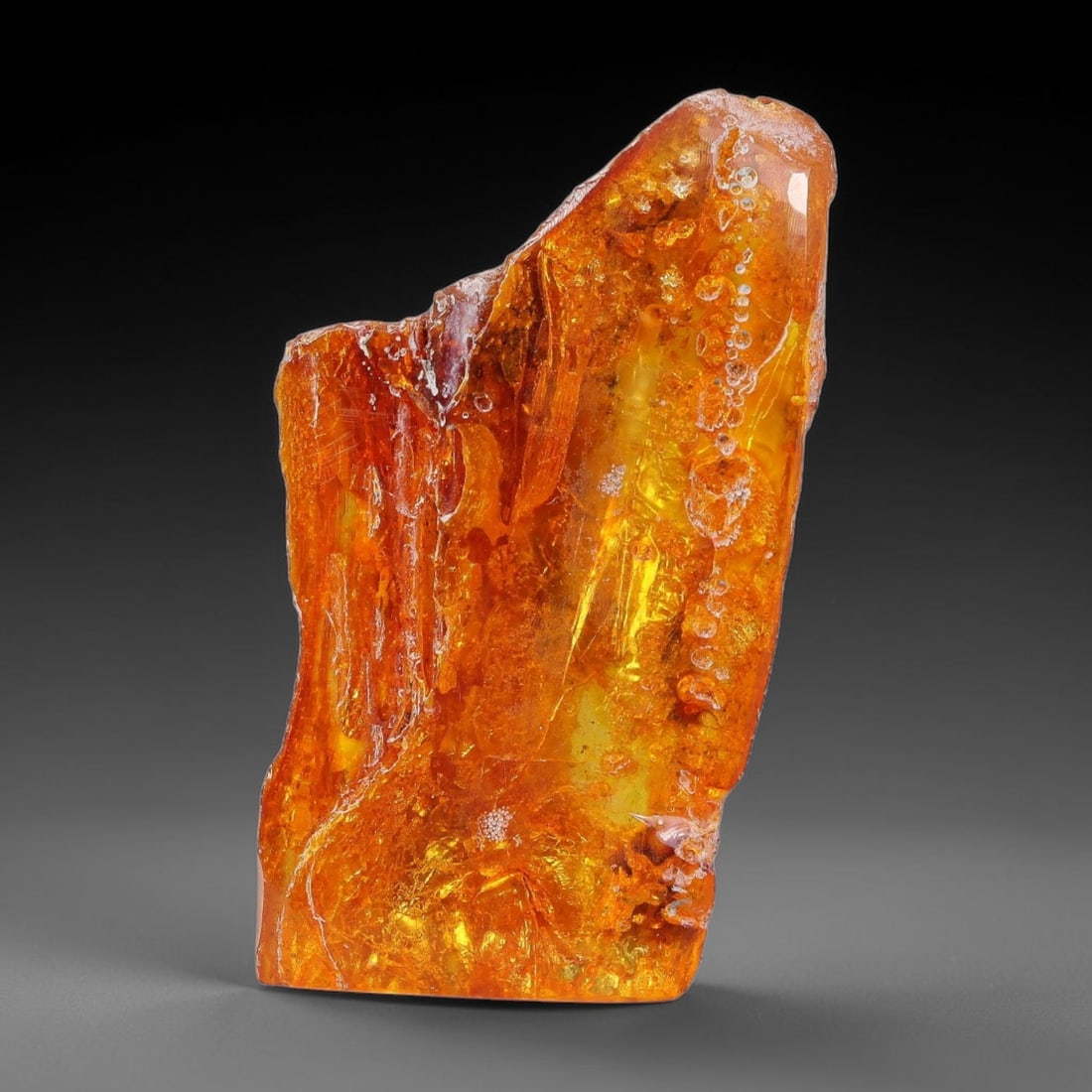 24.77ct Natural Baltic Polished Loose Freeform Amber Gemstone, 44EB: This smoothly polished freeform amber piece carries warm translucent organic clarity with fine natural fossil flecks and tiny mineral inclusions suspended throughout its 39x22mm flowing unstructured s