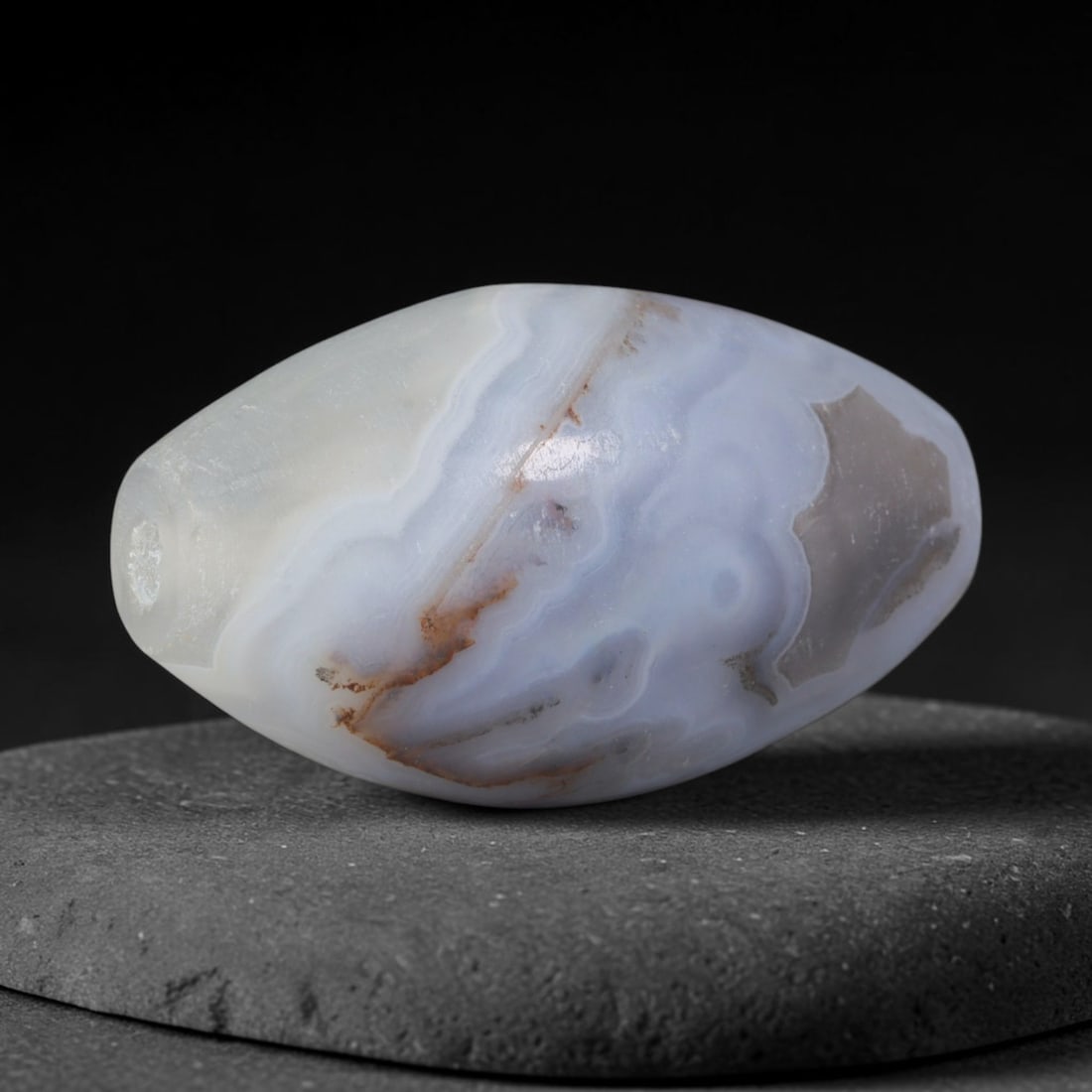 Ancient Achaemenid Persian Wavy Banded Agate Large Barrel Bead (550-330 BCE), 90AD: This substantial antique banded agate barrel bead originates from the Achaemenid Persian Empire, the first unified Persian imperial power renowned for sophisticated lapidary workshops producing ceremo