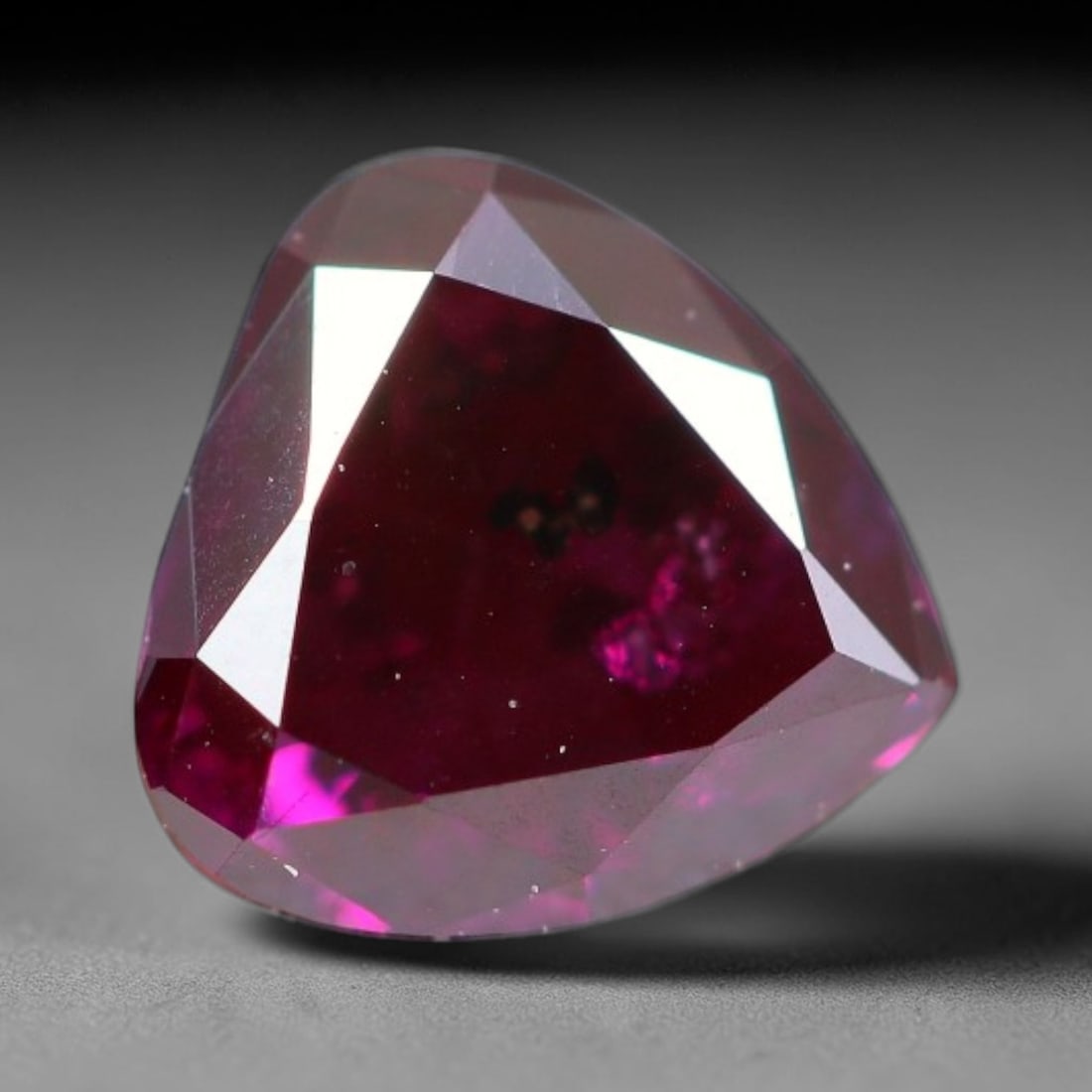0.42ct Natural Fancy Deep Pink Diamond Loose Gemstone, 22BH: This polished natural fancy diamond features rich deep pink colouration, measured at calibrated dimensions of 4.6x4.5x2.6mm. Carefully proportioned pear faceting delivers dynamic light movement, highl