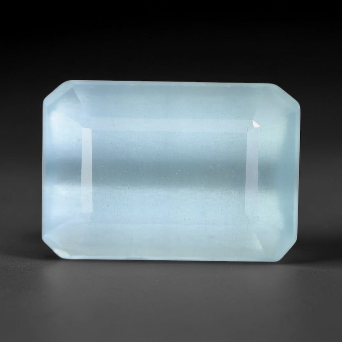 3.85ct Natural Brazilian Soft Sky Blue Faceted Aquamarine Loose Gemstone, 12AS: This expertly faceted aquamarine carries a gentle soft sky blue translucent body with faint fine natural internal mineral markings visible through its polished reflective facets within its 11x7.6x5.7m