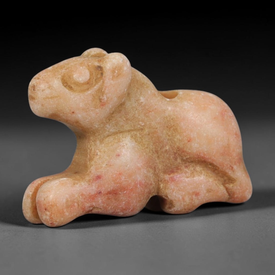 Ancient Egyptian Pale Stone Recumbent Lion Cub Zoomorphic Amulet, 83AA: Genuine ancient Egyptian devotional talisman hand-carved from pale pink cream soft stone, measuring 2cm x 1.4cm. This miniature zoomorphic carving depicts a stylized resting lion cub with rounded faci