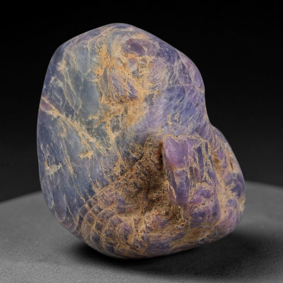 130.68ct Natural Unheated Sri Lankan Purplish Blue Sapphire Rough, 27FC: This natural corundum rough is an unheated purplish blue sapphire sourced from Sri Lankan alluvial gem deposits, featuring an irregular natural native form with residual pale yellow-brown mineral matr