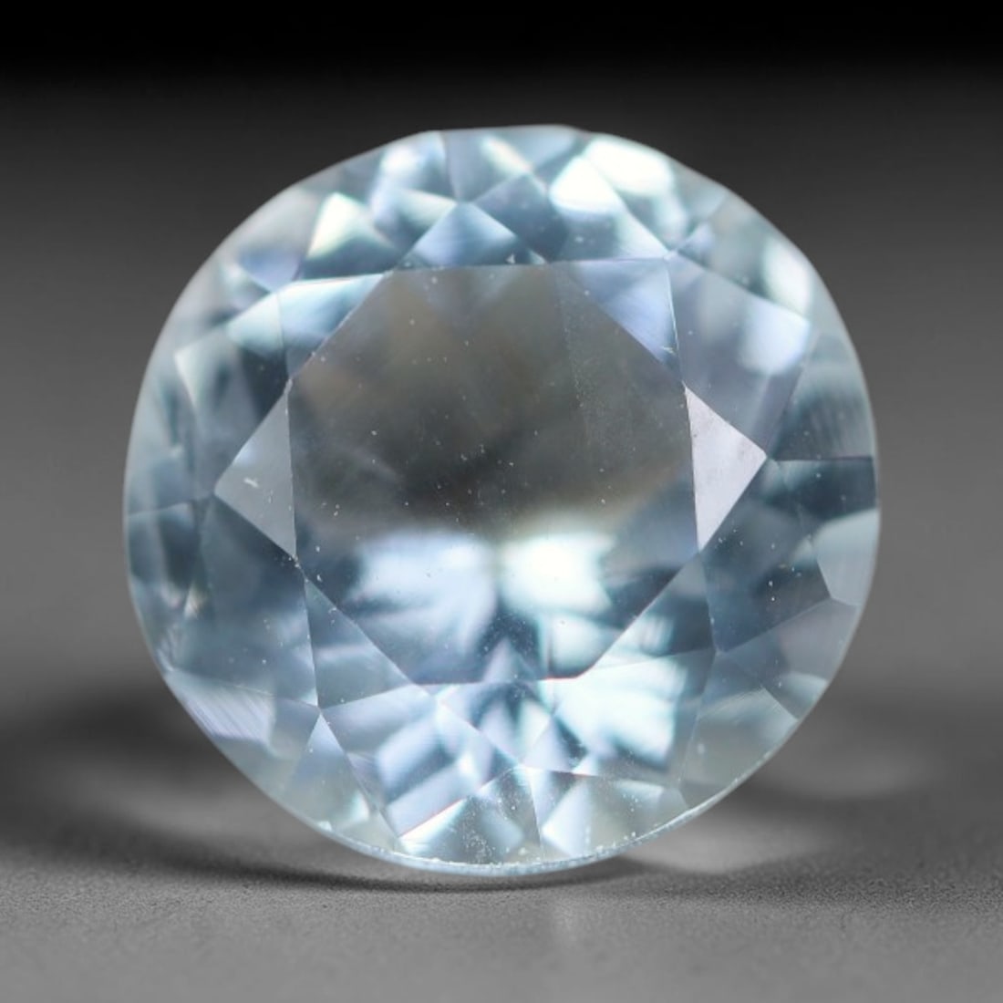 1.98ct Natural Brazilian Sky Blue Faceted Aquamarine Loose Gemstone, 5BC: This precisely faceted aquamarine boasts clear translucent pale sky blue body tone with subtle thin mineral needle and tiny scattered crystalline specks visible within its polished reflective planes i