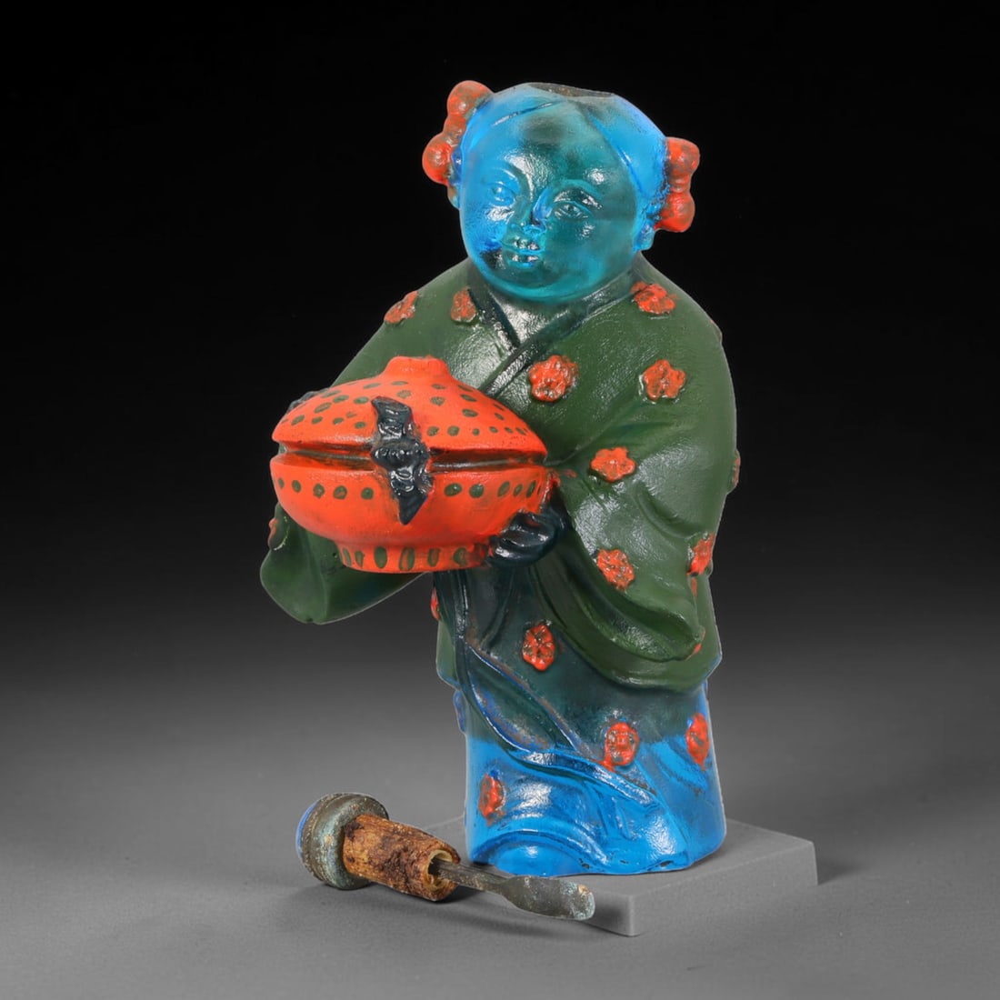 Vintage Chinese Liuli Glass Snuff Bottle - Girl Holding Censer, 29AS: This snuff bottle is cast from translucent blue liuli glass, shaped as a young girl holding a covered censer with bat ornament. The traditional robe is decorated with hand-painted red floral motifs an