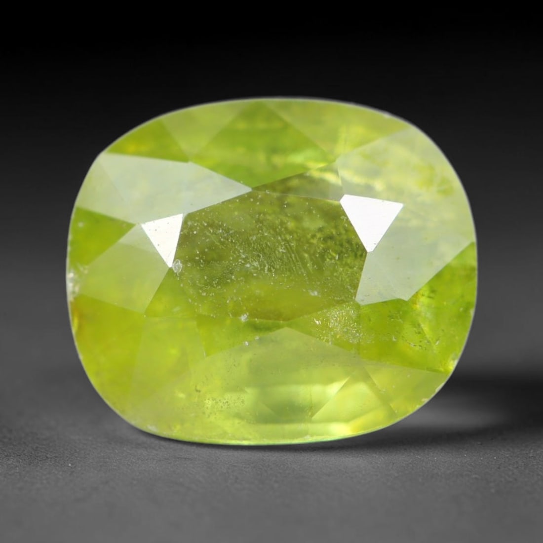 2.31ct Natural Mexican Lime Green Faceted Sphene Loose Gemstone, 60BA: This precisely faceted sphene exhibits vivid translucent lime green body tone, featuring fine natural mineral veils and tiny scattered crystalline micro-inclusions trapped within its high-refractive c