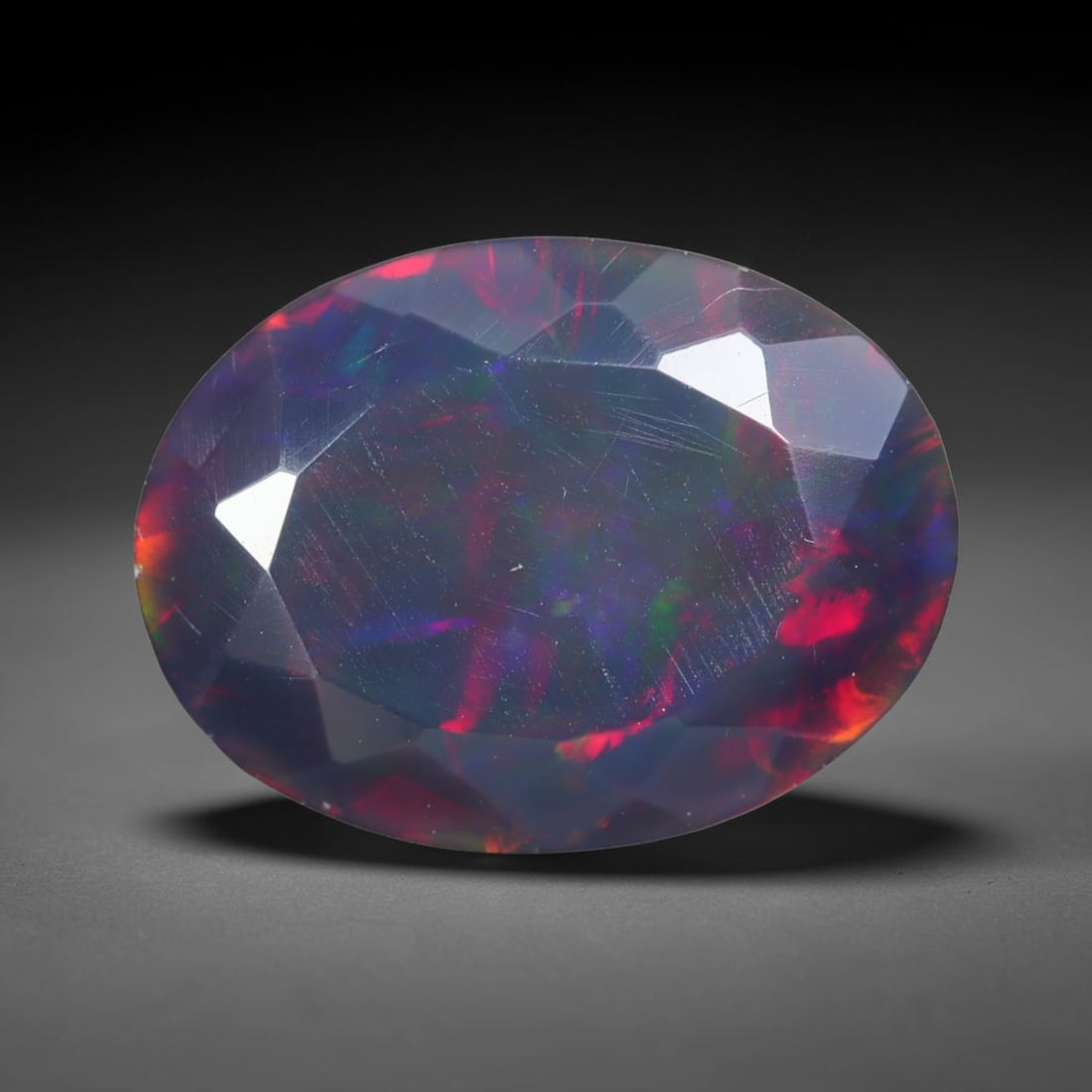 2.94ct Natural Ethiopian Welo Black Smoked Faceted Opal, 14EB: This fully faceted finished opal specimen displays vivid shifting play of color across polished geometric facets within its 13.2x10x5.3mm calibrated dimensions, the dark base body amplifies light move