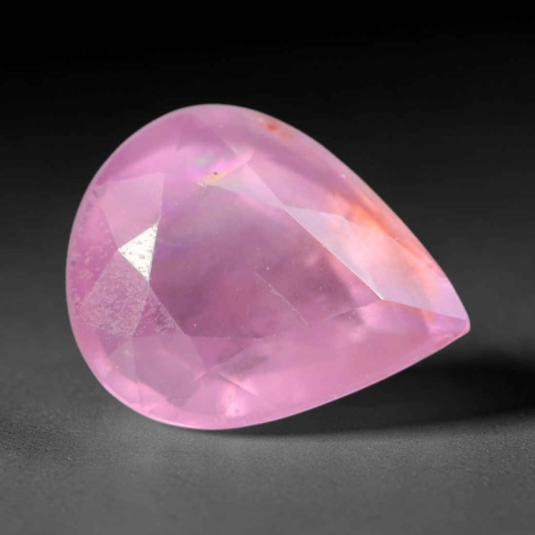 0.96ct Natural Sri Lankan Padparadscha Sapphire Loose Gemstone, 65BC: This fully polished Padparadscha sapphire carries warm blended peach-pink and soft orange body saturation, with subtle microscopic mineral flecks dispersed within its crystalline interior across its c