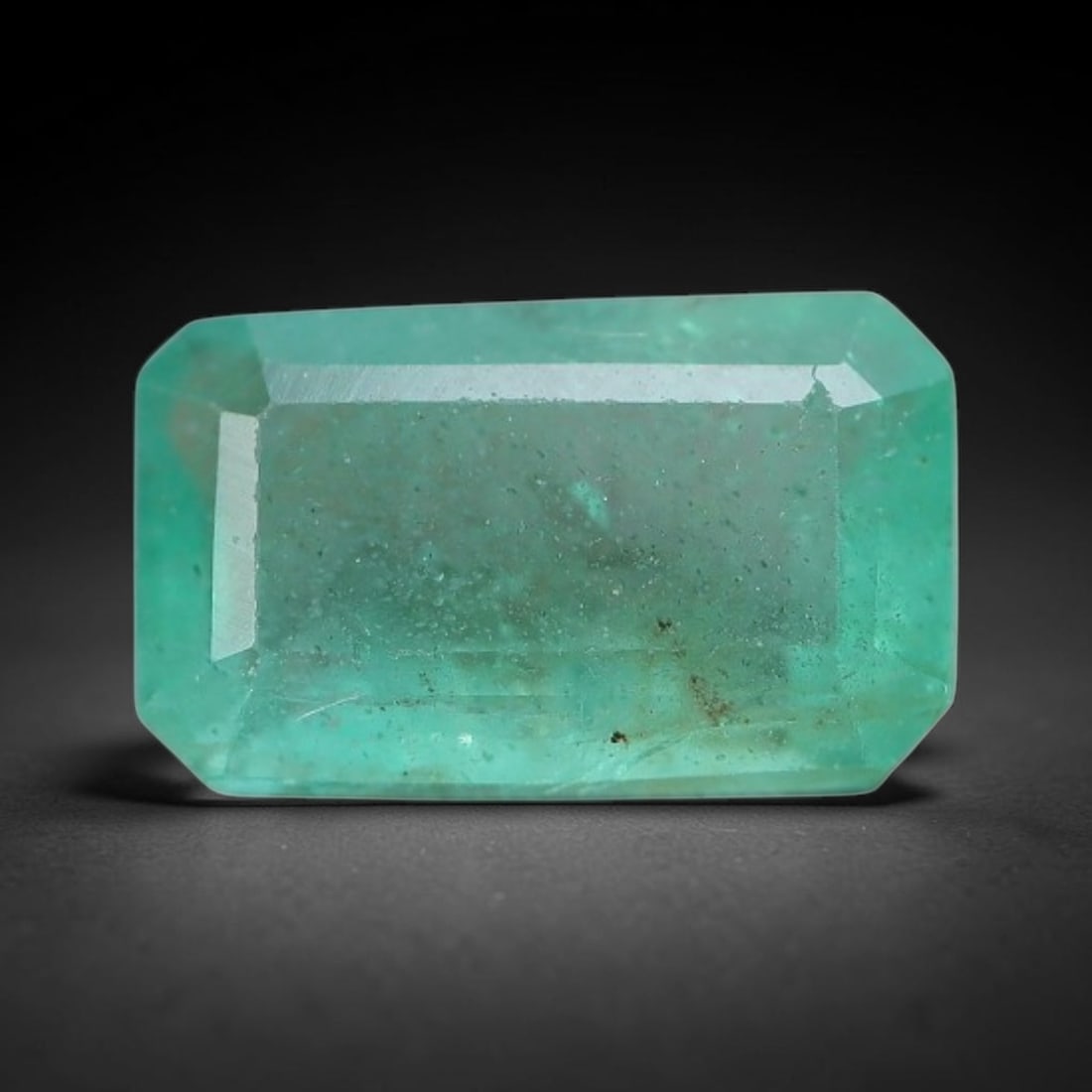 0.87 Carats Natural Zambian Green Emerald Loose Gemstone, 6FP: This green Zambian emerald holds smooth even saturation with subtle faint natural internal markings lending authentic organic character, measured at 7.3x4.4x3.1mm, its calm cool green tone delivers un