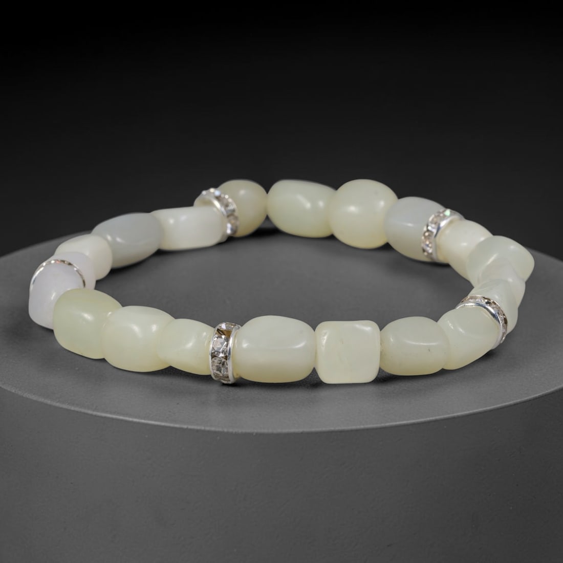 Natural Chinese Xinjiang Hetian Nephrite Pale White Pebble Bracelet, 73AE: Delicate hand-polished natural Xinjiang Hetian nephrite river pebble bracelet featuring soft freeform smooth stones in uniform pale milky celadon white tone, accented by silver-toned metallic spacer r