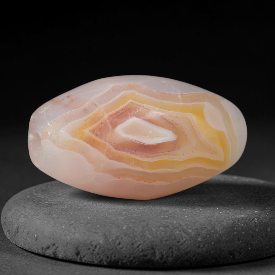 Ancient Achaemenid Persian Peach Amber Banded Agate Barrel Bead (550-330 BCE), 84AD: This striking geometric banded agate barrel bead originates from the Achaemenid Persian Empire, the first great Persian imperial civilization renowned for elite lapidary workshops crafting symbolic ag