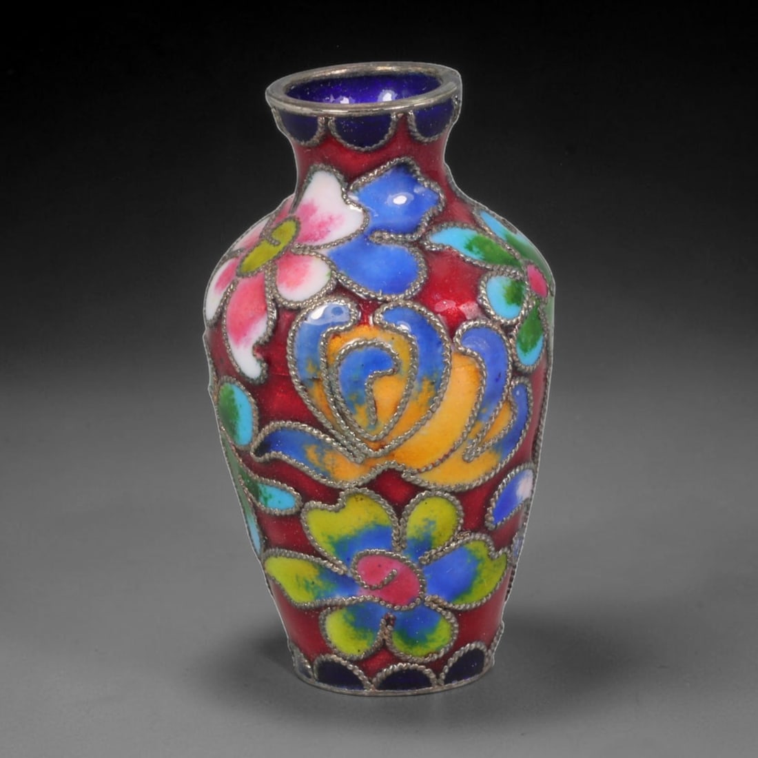 Vintage Chinese Copper Cloisonne Mini Vase - Multicolor Floral Red Enamel Vessel, 40AR: Constructed on a copper base with fine silvered cloisonne wire filigree and hand-fired multi-hued enamel glazes. This slender miniature baluster vase features a rich crimson red enamel ground covering