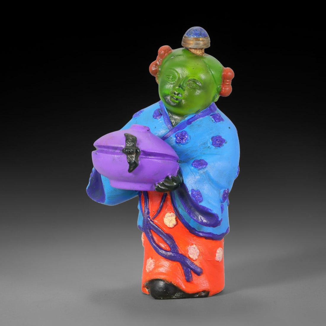 Vintage Chinese Liuli Glass Snuff Bottle - Child Holding Vessel, 33AS: This snuff bottle is moulded from translucent green liuli glass, formed as a standing child figure holding a covered vessel adorned with a bat motif. The robe features hand-painted enamel floral decor