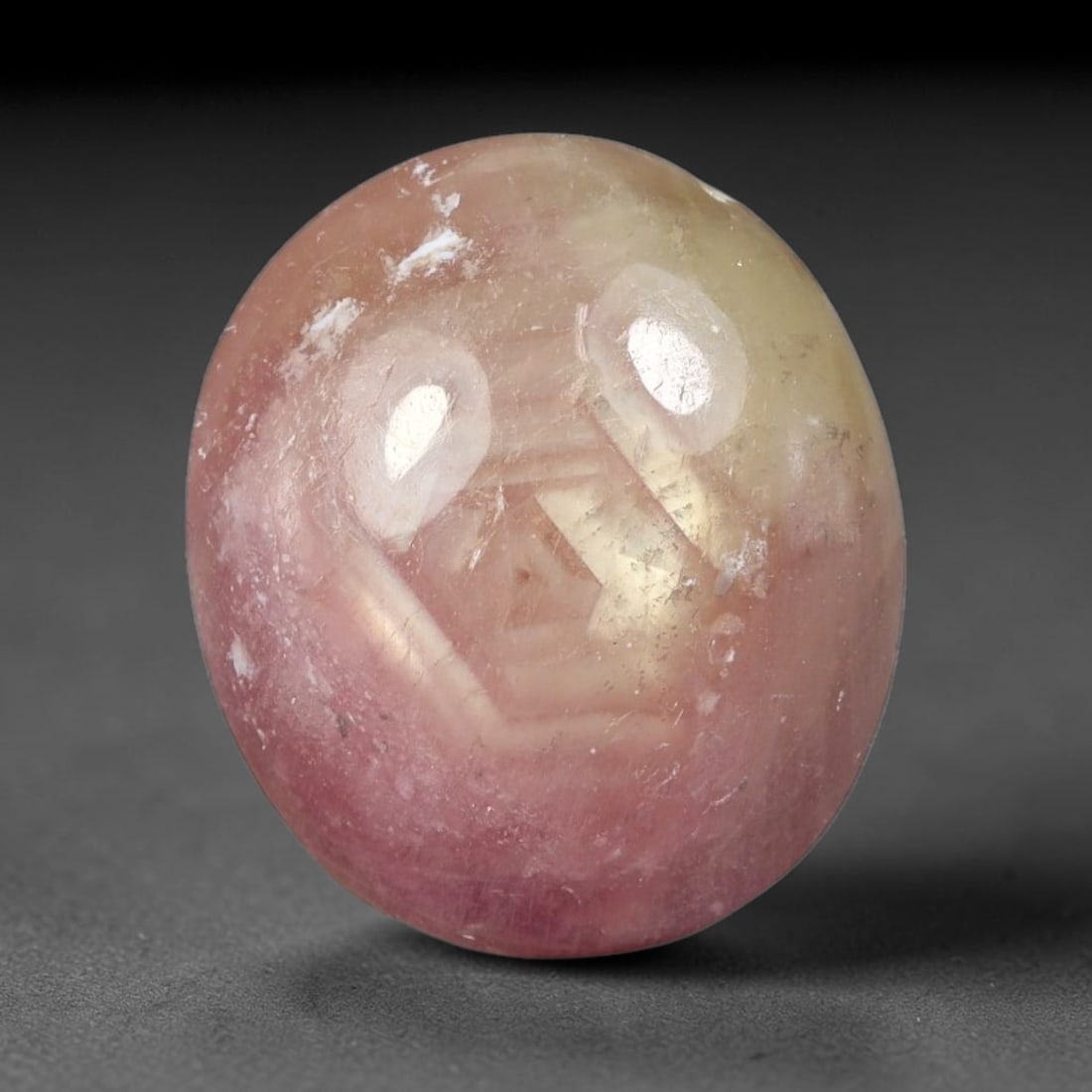 12.20 Carats Natural Madagascar Soft Rose Pink Heated Ruby Cabochon Loose Gemstone, 64FE: This warm blush-toned ruby cabochon carries blended swathes of soft rose pink and gentle peach undertones, with faint natural mineral veining throughout the polished dome, measured at 14.5x12.6x6.6mm.