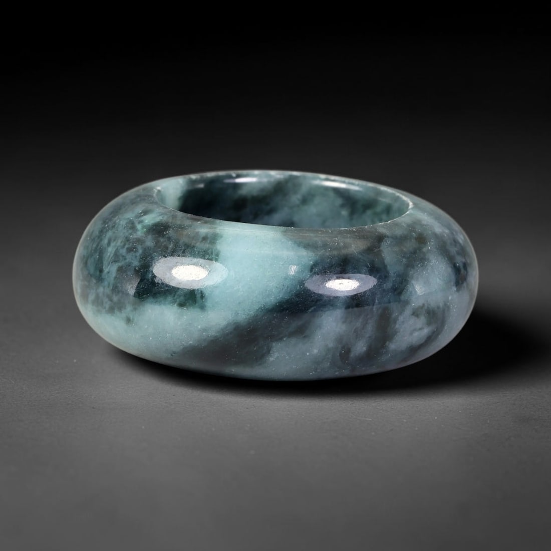 Natural Burmese Type A Jadeite Jade Wide Band Ring, 18BK: Polished untreated Burmese Type A jadeite jade wide band ring, US ring size 13 with a substantial band width of 13 mm. The jadeite features a soft pale mint green base naturally streaked with flowing 