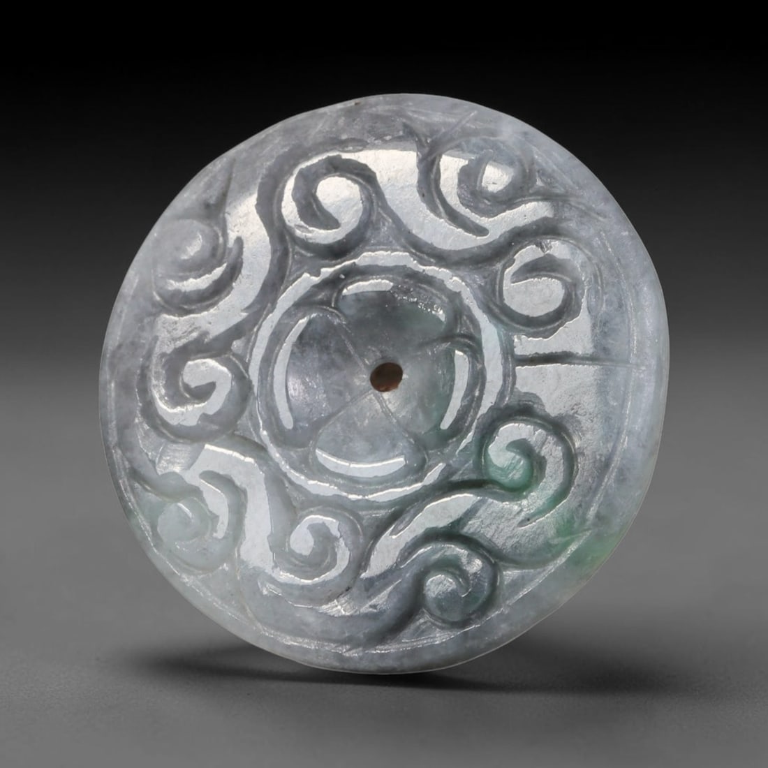 Natural Burmese Type A Jadeite Jade Carved Disc Pendant, 39BP: Artisan hand-carved untreated Burmese Type A jadeite jade circular disc pendant with a 26 mm diameter. The surface is adorned with detailed traditional relief carving finished with a smooth polished s