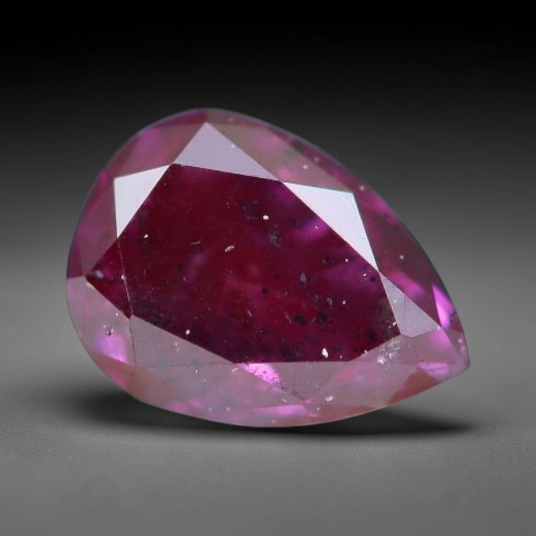 0.23ct Natural Fancy Pinkish Purple Diamond Loose Gemstone, 21BH: This polished natural diamond displays rich pinkish-purple body saturation, with subtle fine microscopic mineral specks distributed within its crystal interior, measured at calibrated dimensions of 4.