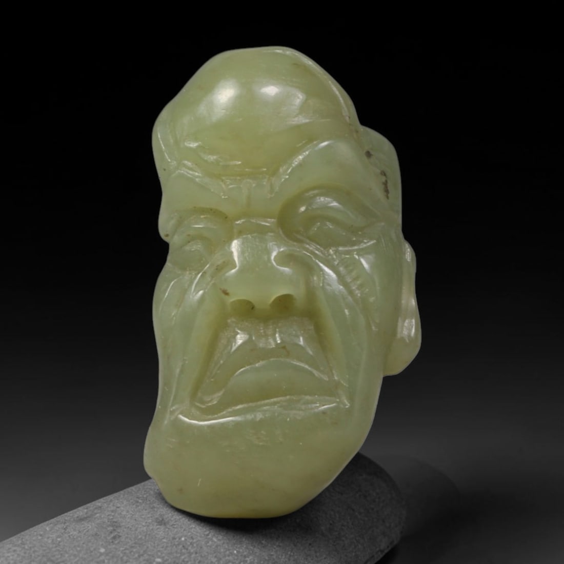Natural Vintage Chinese Nephrite Jade Pale Yellowish Green Arhat Head Carved Face Bead, 34AP: Hand-carved vintage Chinese strung bead crafted from natural vintage Chinese nephrite jade, measuring 3cm x 1.8cm. This barrel-style bead is fully sculpted into a solemn Buddhist Arhat facial bust, wi