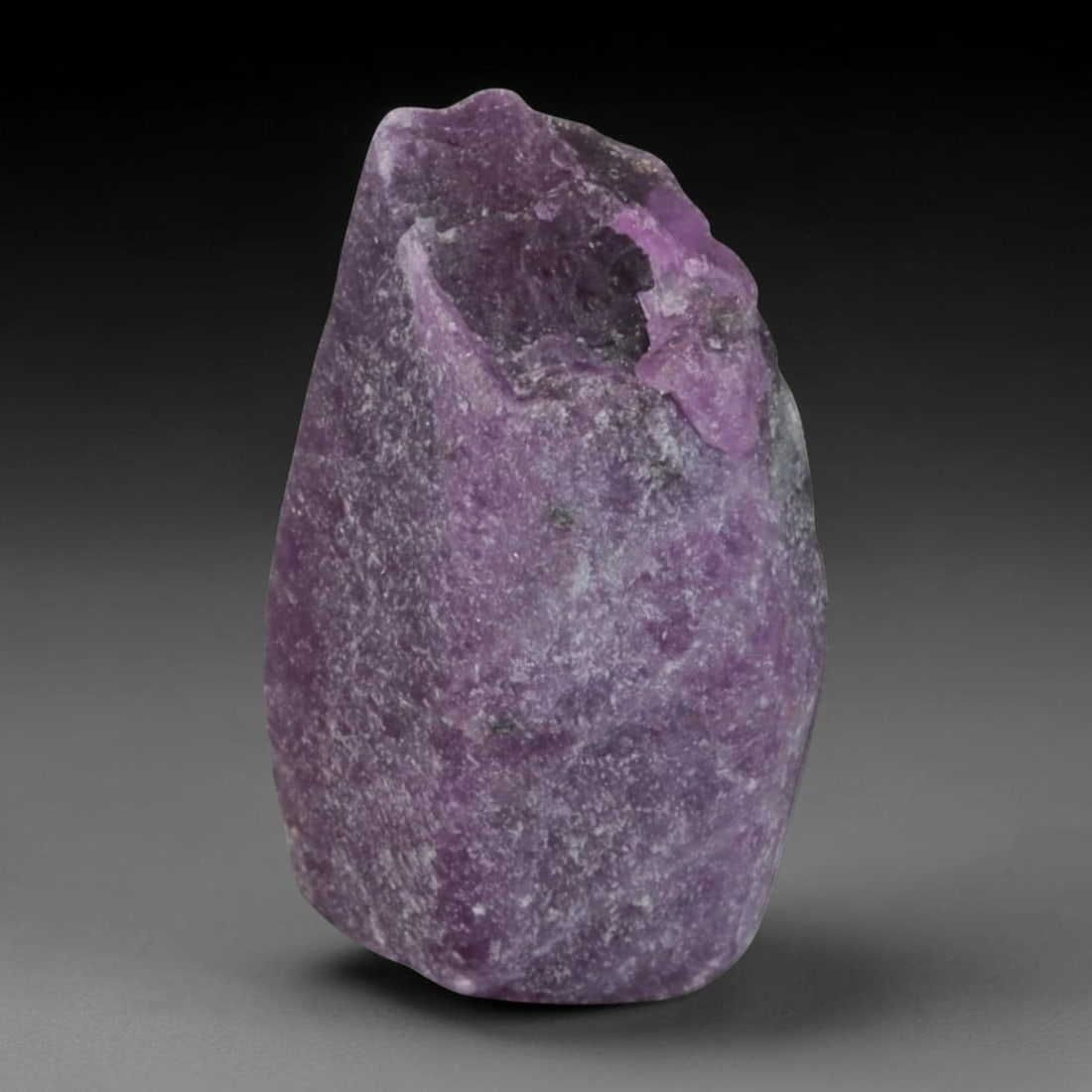 21.74ct Natural Mauritania Ruby Rough (Unheated), 63AM, 63AM: This unheated Mauritania ruby rough is a captivating natural crystal specimen, featuring vivid magenta-purple ruby formations embedded in a contrasting greyish matrix. The stone's rugged, unpolished s