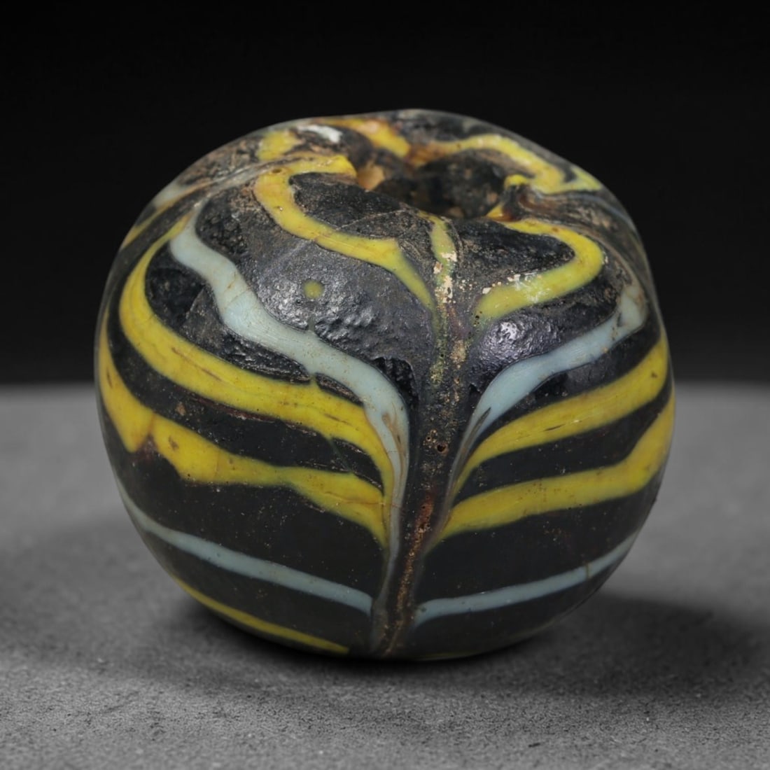 Ancient Islamic Hand Crafted Glass Bead Talisman, 35AC, 35AC: Miniature antique wearable bead formed from hand-worked glass material, originating from ancient Islamic period glassmaking traditions across the Near East and North African cultural spheres. Glass wa