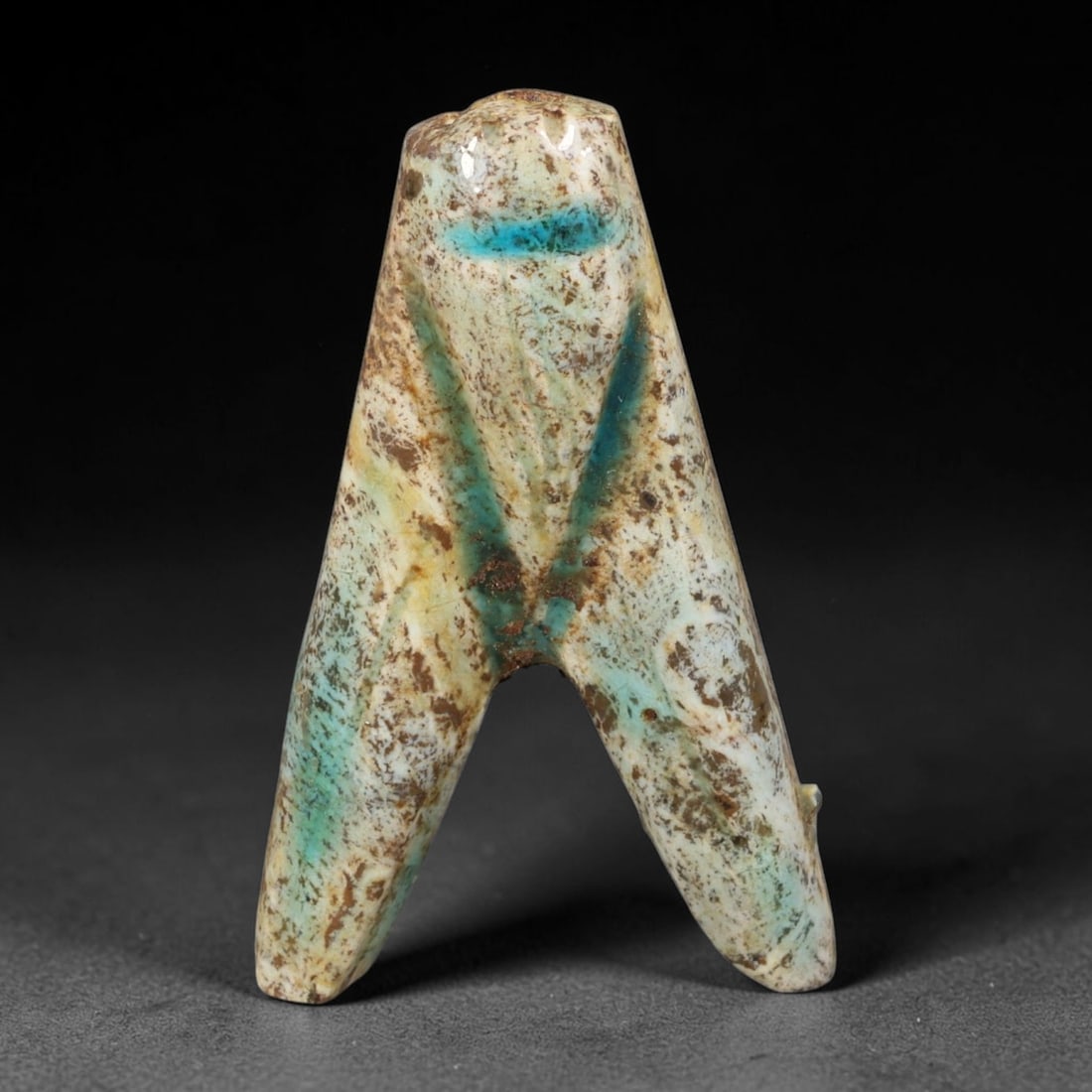 Ancient Egyptian Faience Fly Amulet (New Kingdom 1550-1070 BCE), 94AE, 94AE: Hand-moulded glazed faience fly protective amulet originating from Ancient Egyptian New Kingdom ritual craft. Classic bifurcated fly body form with natural weathered turquoise glaze mottled by heavy b