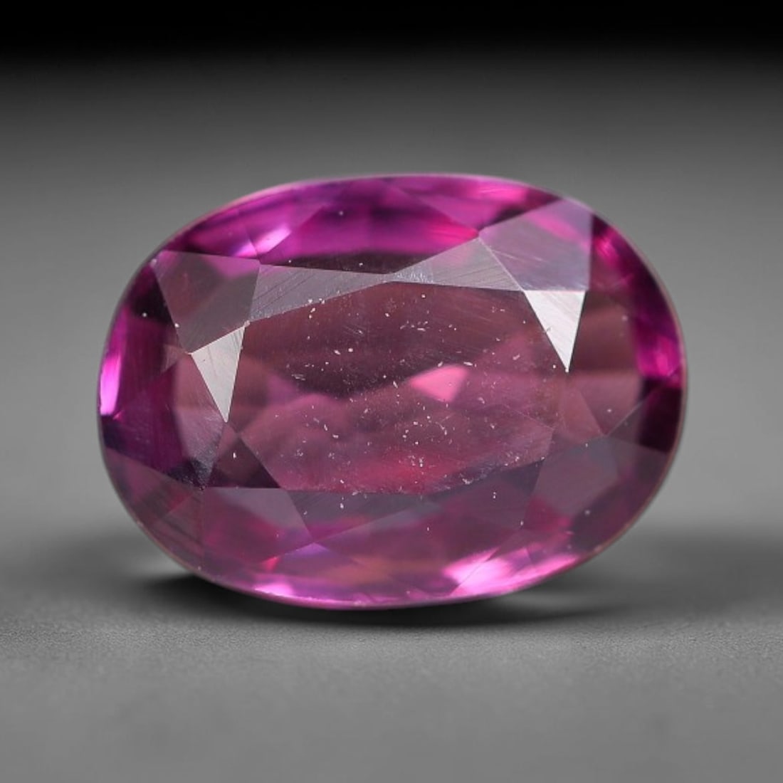 1.05ct Natural Tanzanian Rhodolite Grape Garnet Faceted Loose Gemstone, 5BE, 5BE: This expertly faceted grape garnet, a scarce saturated purple-magenta rhodolite variant, features transparent crystal structure dotted with faint microscopic mineral specks within its precisely cut re