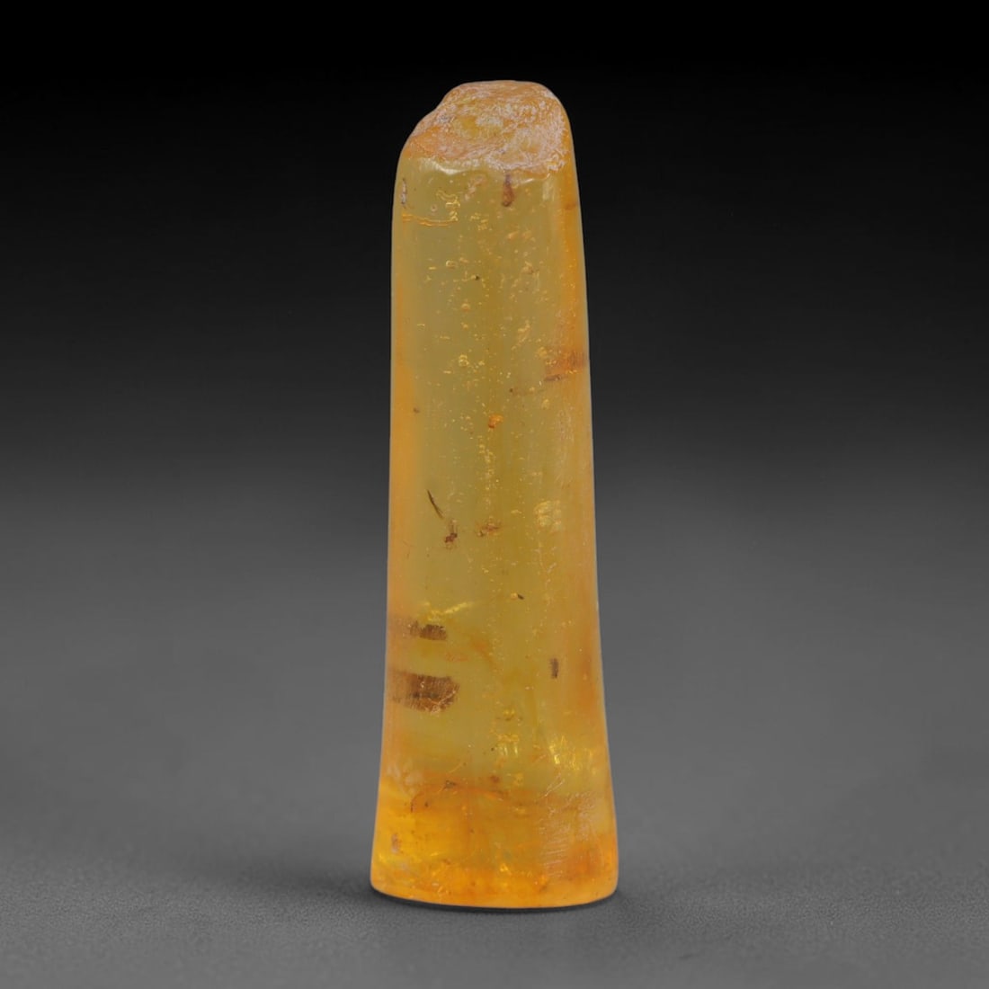 11.83ct Natural Baltic Polished Loose Freeform Amber Gemstone, 40AT, 40AT: This smoothly polished freeform amber piece carries warm translucent organic clarity with fine natural fossil flecks and tiny mineral inclusions suspended throughout its 35x10mm flowing unstructured s