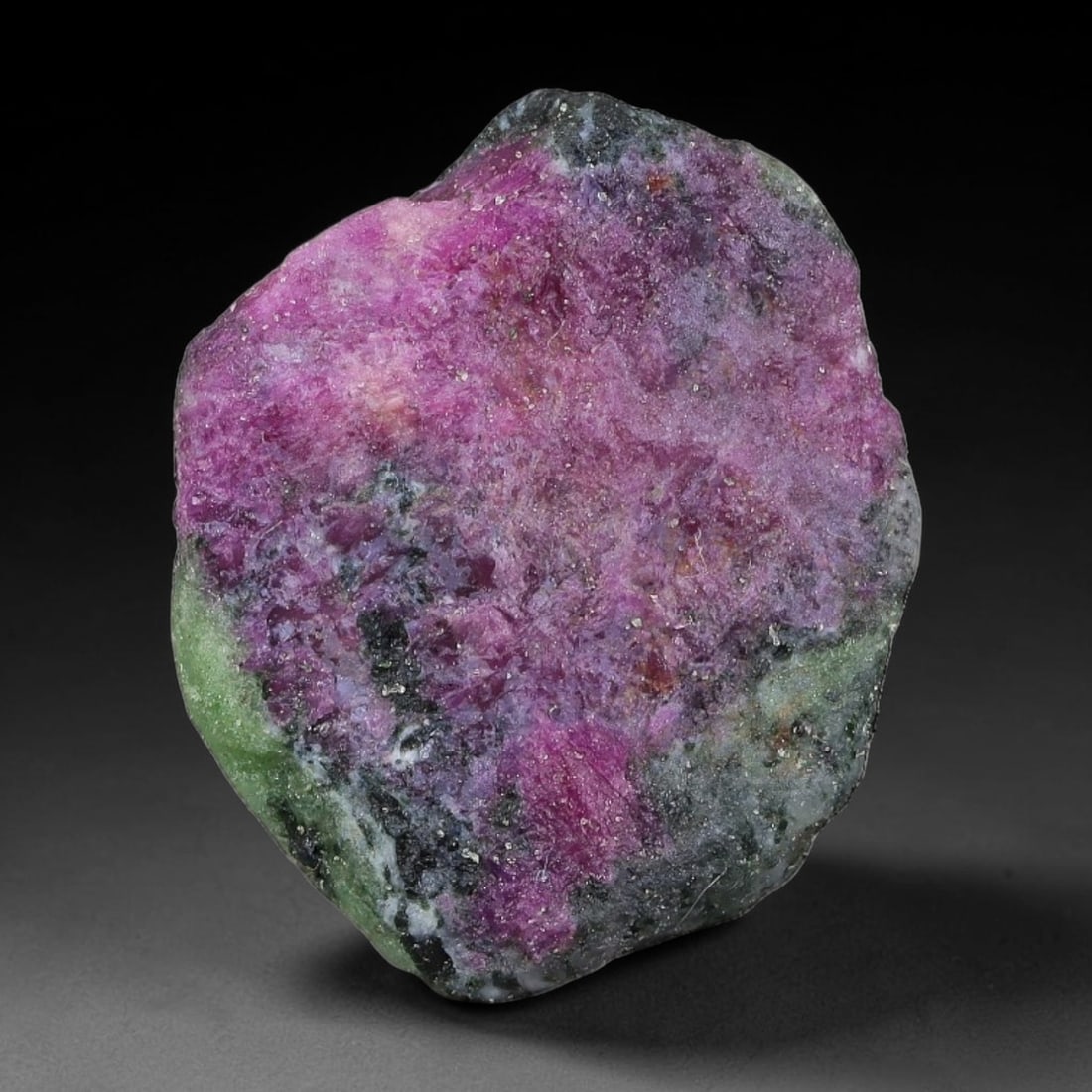 52ct Natural Tanzanian Ruby Zoisite Raw Rough Specimen Mineral Stone, 22FC, 22FC: This unpolished mineral rough is natural ruby zoisite sourced from Tanzania, exhibiting distinct banded mineral segregation of vibrant green zoisite, magenta ruby crystals, and dark hornblende inclusi