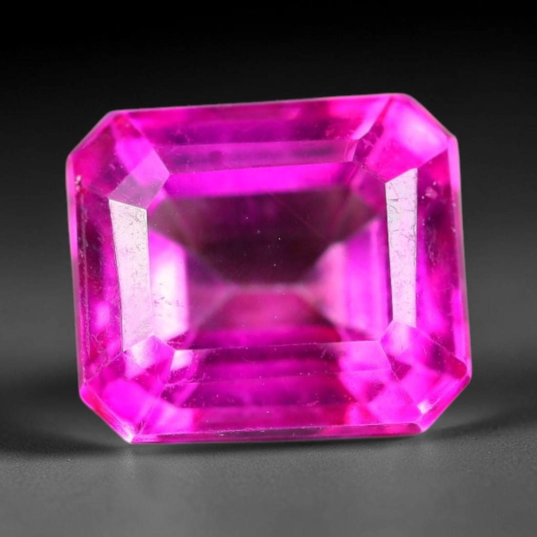 7.68 Carats Natural Brazil Hot Pink Topaz Loose Gemstone, 15FE, 15FE: This natural Brazil topaz holds dimension measurements of 10.5x9.3x7.3mm, displaying an intense vibrant hot pink shade created through surface color coating treatment, its transparent crystal body car