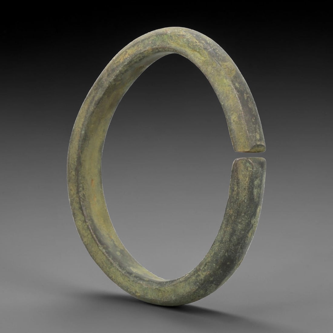 Ancient Roman Bronze Bracelet - Flat Open Form, 72BN, 72BN: Crafted from bronze, this open bracelet features a thick, flat cross-section and a simple C-shaped form with a narrow gap between squared terminals. The surface displays a uniform greenish patina, ind