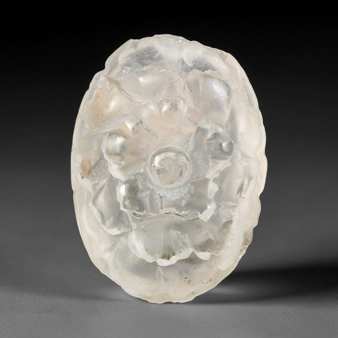Natural Brazilian Phantom Quartz Hand Carved Floral Gemstone, 44BS: This hand-carved floral specimen is crafted from natural phantom quartz. Intricate layered floral detailing wraps across the stone's surface, while translucent quartz matrix reveals subtle internal ph